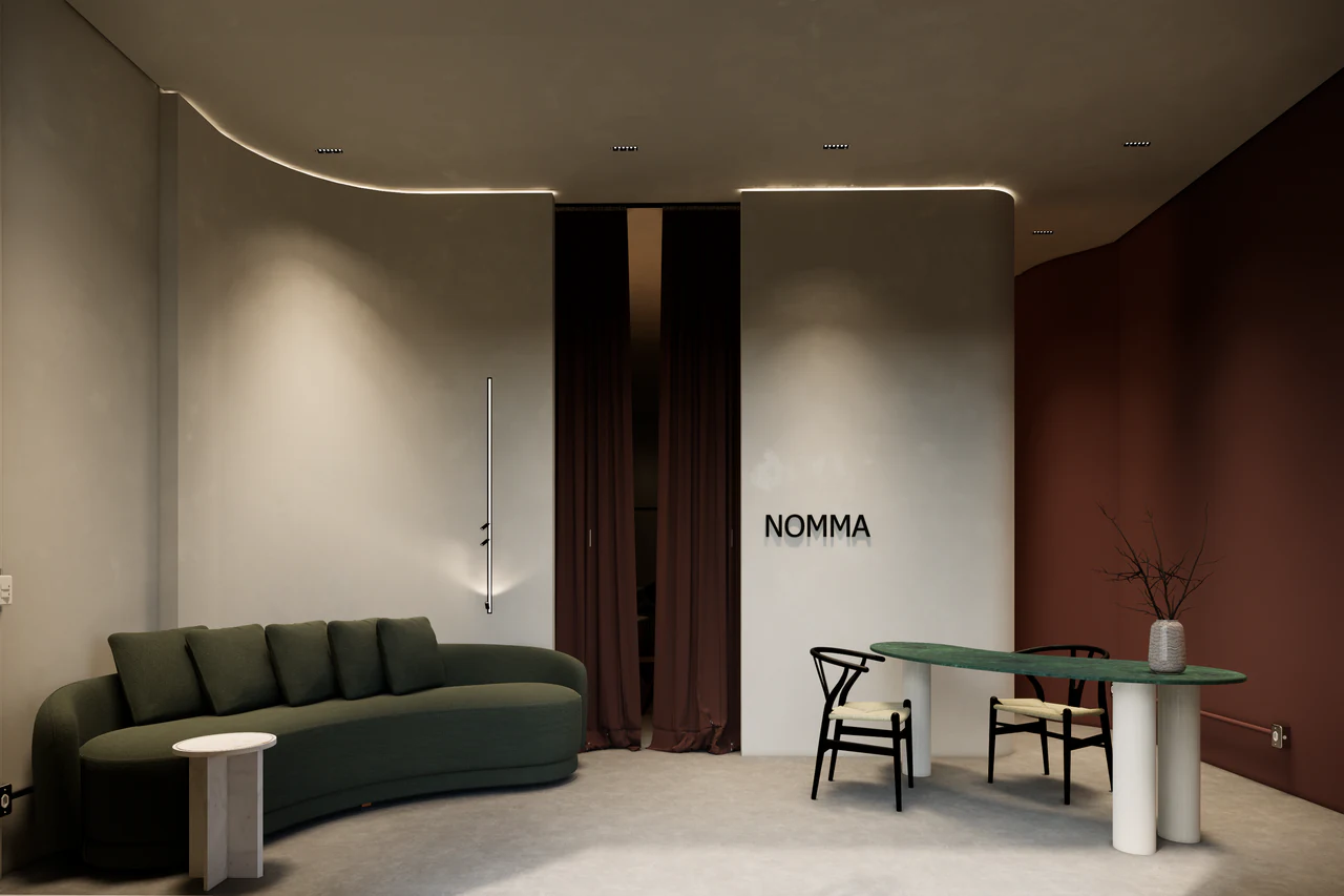 Lounge do Nomma com sofá verde, curvas e mesa